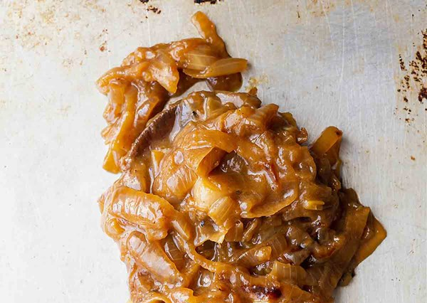 Closeup of caramelized onions on a sheet pan